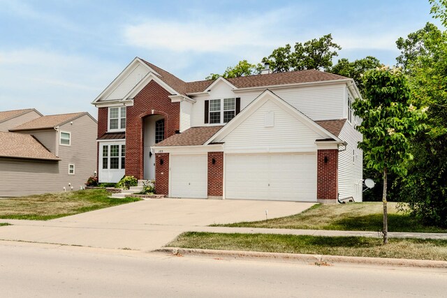 105 Black Hill Dr, Streamwood, IL 60107 - traditional home featuring a garage, brick siding, concrete driveway, and a front lawn