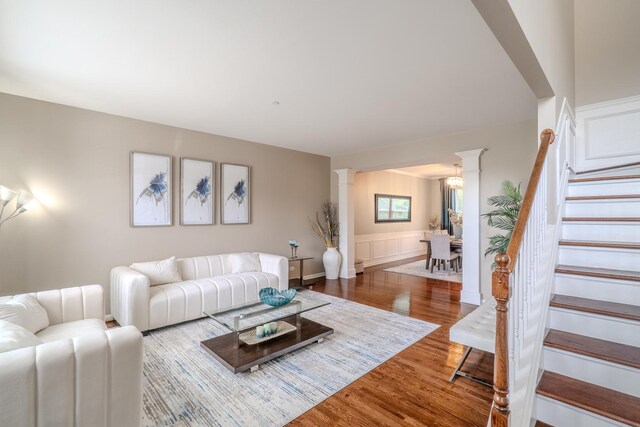 105 Black Hill Dr, Streamwood, IL 60107 - living area featuring ornate columns, wood finished floors, and stairway