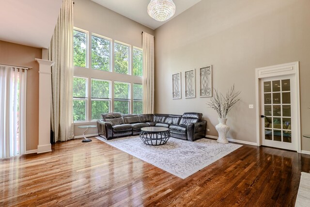 105 Black Hill Dr, Streamwood, IL 60107 - living room with a towering ceiling, wood finished floors, and a chandelier