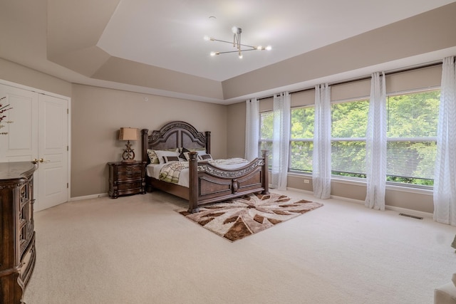105 Black Hill Dr, Streamwood, IL 60107 - bedroom with light colored carpet, a chandelier, and a raised ceiling