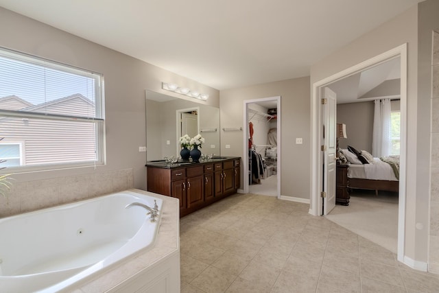 105 Black Hill Dr, Streamwood, IL 60107 - ensuite bathroom featuring double vanity, a jetted tub, healthy amount of natural light, and a walk in closet