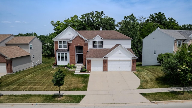 105 Black Hill Dr, Streamwood, IL 60107 - traditional home with brick siding, concrete driveway, and a front lawn