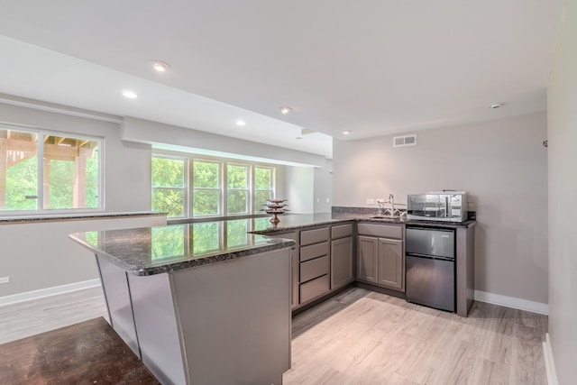 105 Black Hill Dr, Streamwood, IL 60107 - kitchen with fridge, a peninsula, stainless steel microwave, plenty of natural light, and recessed lighting