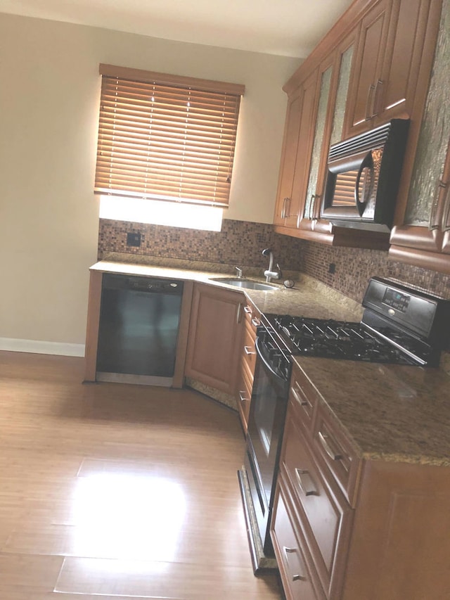 2121 N Saint Louis Ave Unit 3S, Chicago, IL 60647 - kitchen with black microwave, dishwasher, gas stove, light wood finished floors, and tasteful backsplash