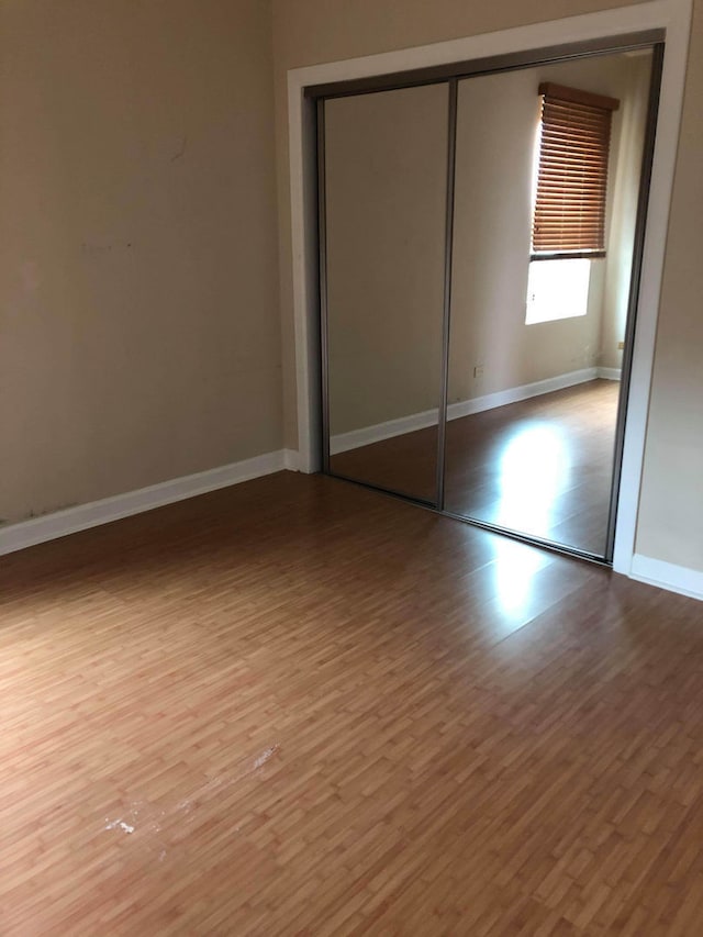 2121 N Saint Louis Ave Unit 3S, Chicago, IL 60647 - unfurnished bedroom with wood finished floors and a closet