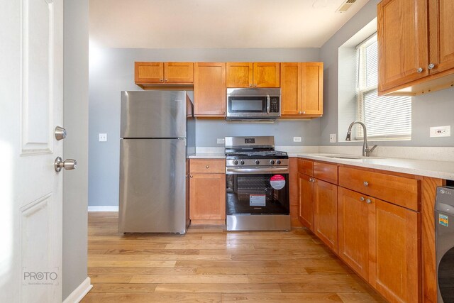 4752 N Albany Ave Unit 3, Chicago, IL 60625 - kitchen featuring stainless steel appliances, light wood-style flooring, and light countertops