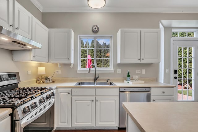1312 Dorchester Dr, Mundelein, IL 60060 - kitchen with appliances with stainless steel finishes, under cabinet range hood, white cabinets, and ornamental molding