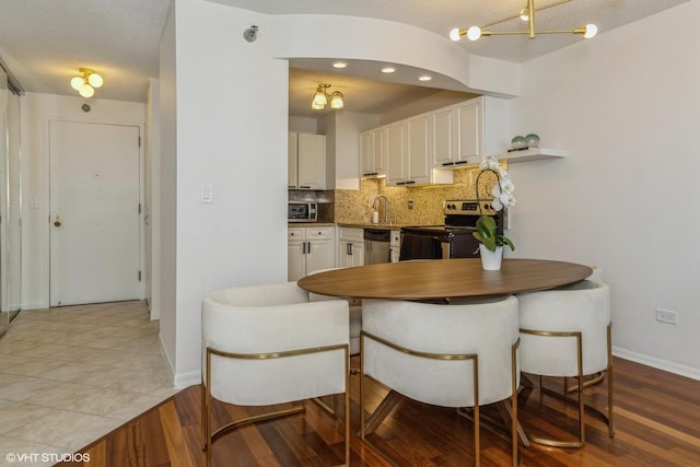 111 W Maple St Unit 2803, Chicago, IL 60610 - dining space with a chandelier and wood finished floors