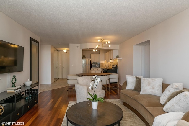 111 W Maple St Unit 2803, Chicago, IL 60610 - living area featuring dark wood finished floors, a textured ceiling, and a chandelier