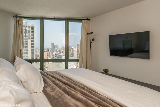 111 W Maple St Unit 2803, Chicago, IL 60610 - bedroom with floor to ceiling windows, access to outside, and a textured ceiling