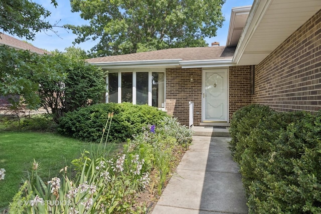 7769 Danbury Dr, Darien, IL 60561 - property entrance with brick siding, a yard, and a shingled roof