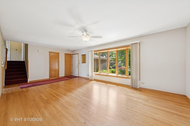 7769 Danbury Dr, Darien, IL 60561 - unfurnished living room with a ceiling fan, light wood-type flooring, and stairway