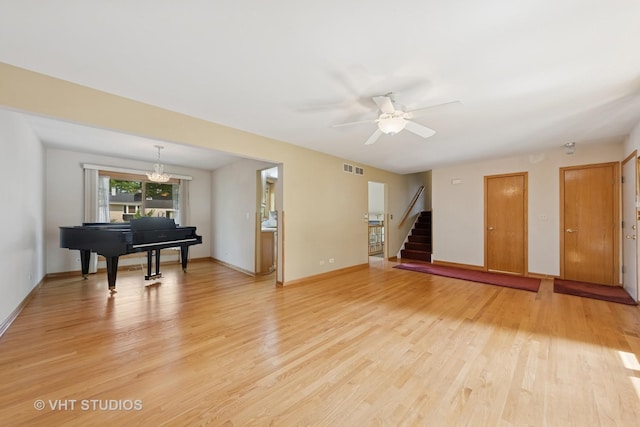 7769 Danbury Dr, Darien, IL 60561 - living room featuring light wood-style floors, stairs, ceiling fan, and a chandelier