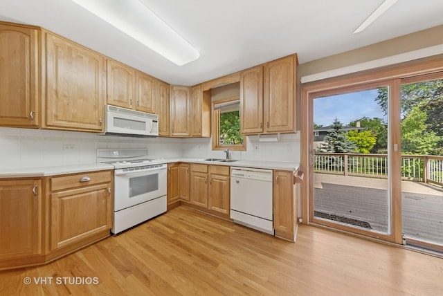 7769 Danbury Dr, Darien, IL 60561 - kitchen featuring white appliances, light wood-style floors, backsplash, and light countertops