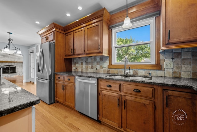 342 Dilorenzo Dr, Naperville, IL 60565 - kitchen with appliances with stainless steel finishes, brown cabinetry, light wood-style floors, decorative light fixtures, and recessed lighting