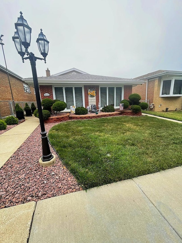 10752 S S Ave E, Chicago, IL 60617 - single story home featuring a front lawn and brick siding