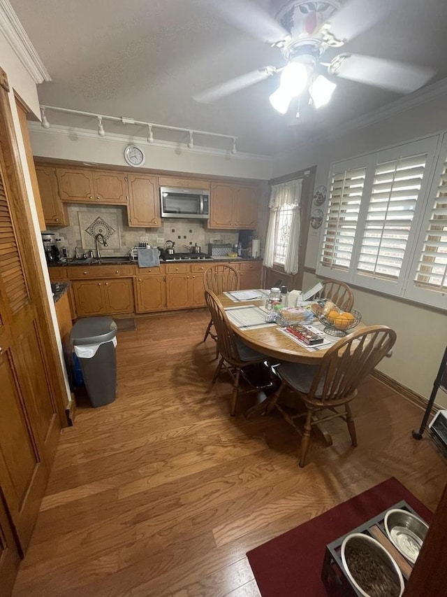 10752 S S Ave E, Chicago, IL 60617 - dining room with ceiling fan, light wood-style flooring, ornamental molding, and rail lighting