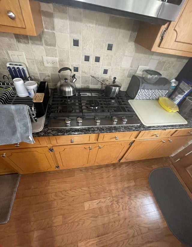 10752 S S Ave E, Chicago, IL 60617 - kitchen with gas stovetop, backsplash, dark countertops, and brown cabinetry