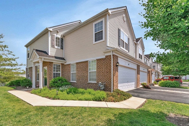 5011 Elmira Ct, Plainfield, IL 60586 - view of front facade with an attached garage, brick siding, driveway, and a front lawn