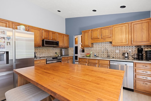 5555 Raspberry Trl, Rockford, IL 61114 - kitchen featuring appliances with stainless steel finishes, butcher block countertops, and decorative backsplash