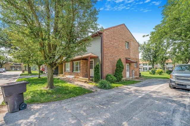17 Michael Rd, Park Forest, IL 60466 - view of front of home with brick siding, a front lawn, and driveway