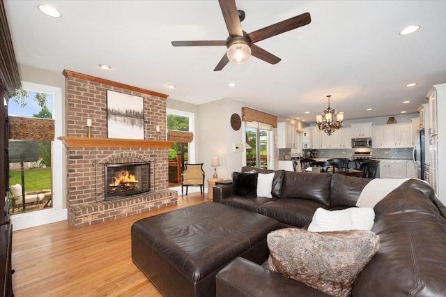 601 W Crockett Ave, Elmhurst, IL 60126 - living area featuring a chandelier, ceiling fan, a fireplace, light wood-style floors, and recessed lighting