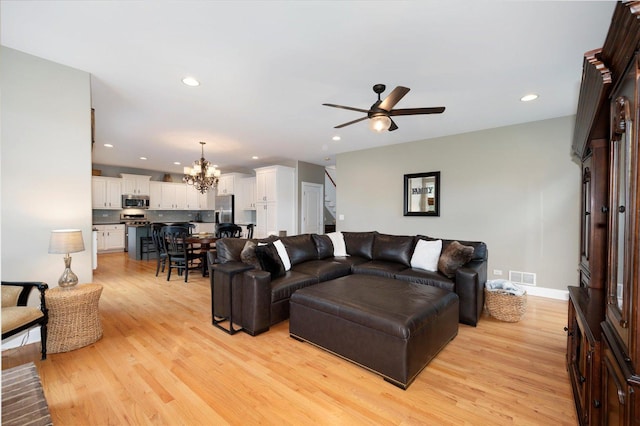 601 W Crockett Ave, Elmhurst, IL 60126 - living room with a chandelier, light wood-style flooring, recessed lighting, ceiling fan, and stairs