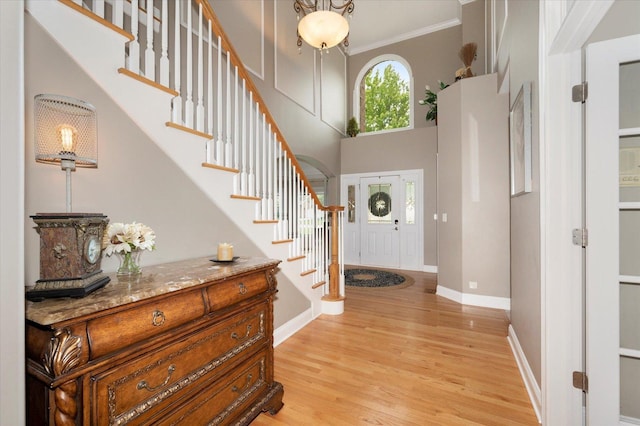 601 W Crockett Ave, Elmhurst, IL 60126 - foyer entrance featuring light wood finished floors, stairs, ornamental molding, and a high ceiling