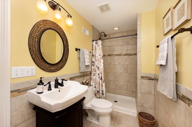 601 W Crockett Ave, Elmhurst, IL 60126 - bathroom with tile walls, tile patterned flooring, vanity, a tile shower, and a wainscoted wall