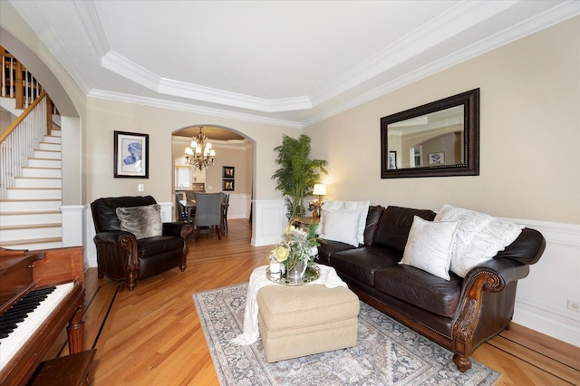 601 W Crockett Ave, Elmhurst, IL 60126 - living room featuring arched walkways, a chandelier, stairway, crown molding, and light wood finished floors