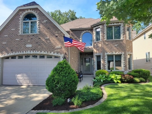 601 W Crockett Ave, Elmhurst, IL 60126 - view of front of property with brick siding, concrete driveway, and a front yard