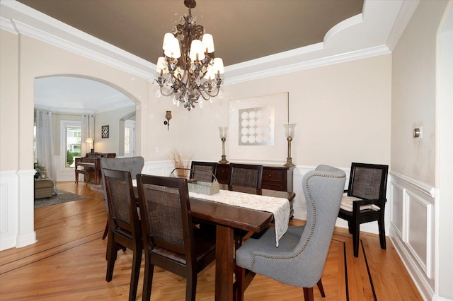 601 W Crockett Ave, Elmhurst, IL 60126 - dining space with arched walkways, light wood finished floors, crown molding, wainscoting, and a chandelier