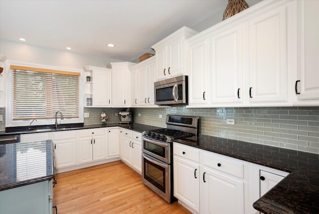 601 W Crockett Ave, Elmhurst, IL 60126 - kitchen featuring appliances with stainless steel finishes, white cabinets, dark stone counters, backsplash, and recessed lighting