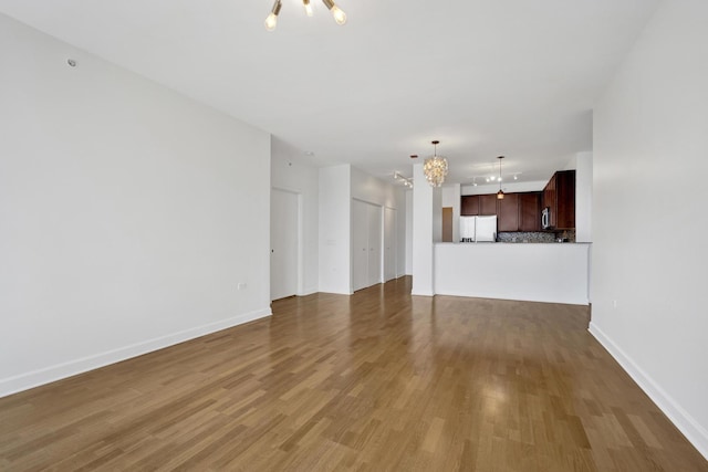 100 E 14th St Unit 2007, Chicago, IL 60605 - unfurnished living room with a chandelier and wood finished floors