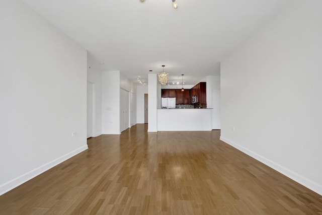 100 E 14th St Unit 2007, Chicago, IL 60605 - unfurnished living room featuring a chandelier and wood finished floors
