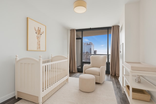 100 E 14th St Unit 2007, Chicago, IL 60605 - bedroom featuring floor to ceiling windows and wood finished floors