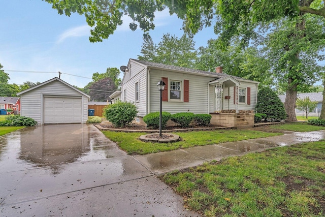 505 Douglas St, Morris, IL 60450 - view of front facade with driveway, a chimney, a detached garage, an outdoor structure, and a front yard