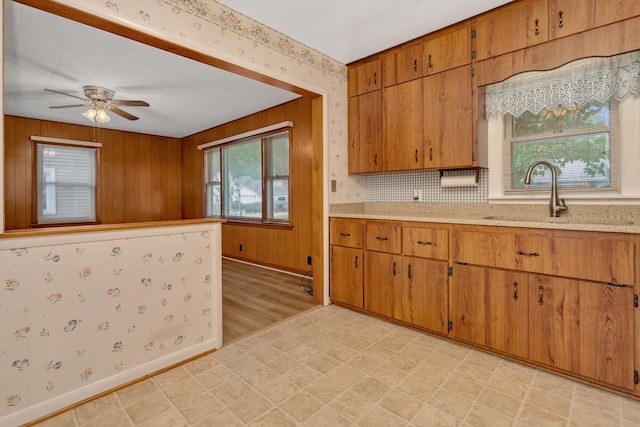505 Douglas St, Morris, IL 60450 - kitchen featuring plenty of natural light, light countertops, light floors, brown cabinets, and wallpapered walls