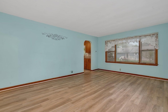 505 Douglas St, Morris, IL 60450 - empty room featuring arched walkways and light wood-style flooring