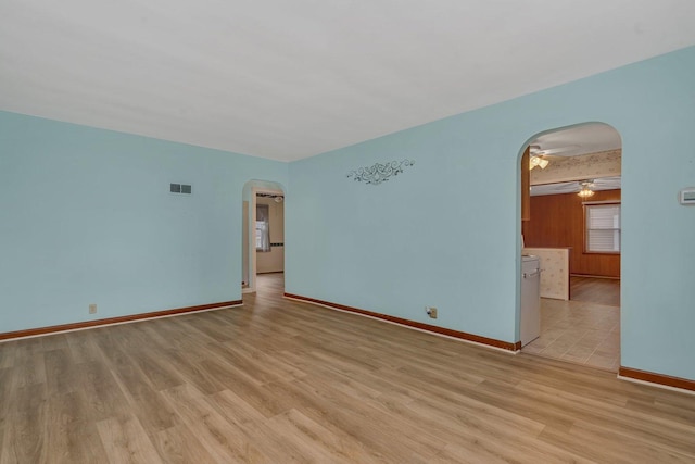 505 Douglas St, Morris, IL 60450 - empty room with arched walkways, light wood-style flooring, and a ceiling fan
