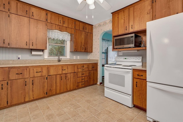 505 Douglas St, Morris, IL 60450 - kitchen with white appliances, a ceiling fan, light countertops, backsplash, and wallpapered walls