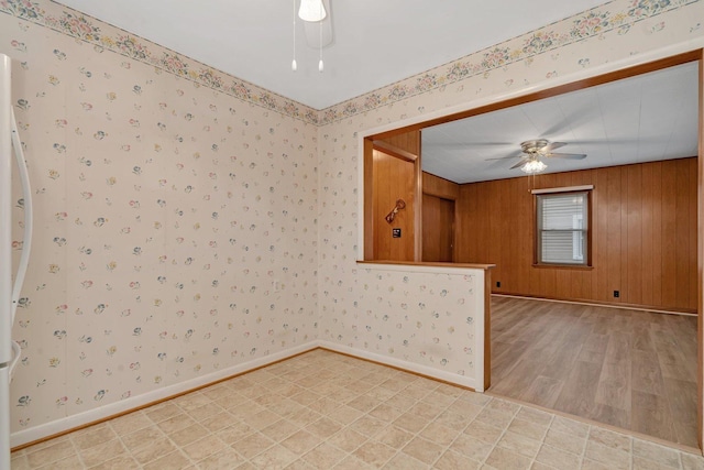 505 Douglas St, Morris, IL 60450 - empty room featuring ceiling fan, wallpapered walls, and light wood-style floors