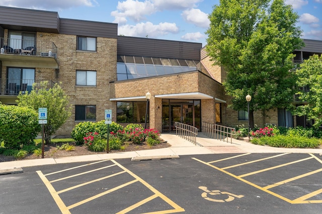 5550 Astor Ln Unit 214, Rolling Meadows, IL 60008 - view of property featuring uncovered parking
