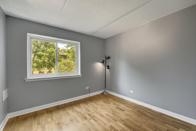 5550 Astor Ln Unit 214, Rolling Meadows, IL 60008 - unfurnished room featuring light wood-type flooring and a textured ceiling