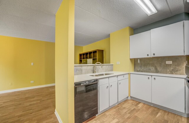 5550 Astor Ln Unit 214, Rolling Meadows, IL 60008 - kitchen with black dishwasher, light wood-style flooring, backsplash, light countertops, and a textured ceiling