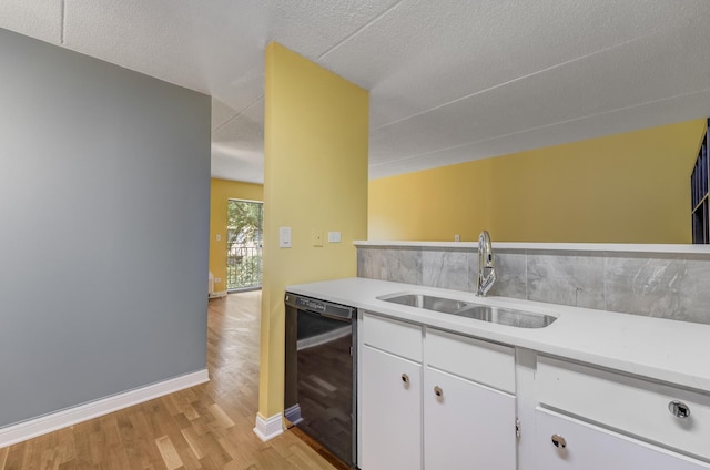5550 Astor Ln Unit 214, Rolling Meadows, IL 60008 - kitchen featuring dishwasher, light wood-style floors, light countertops, white cabinets, and a textured ceiling