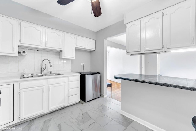 9205 Potter Rd Unit 1C, Des Plaines, IL 60016 - kitchen with white cabinets, a ceiling fan, light marble finish flooring, and fridge