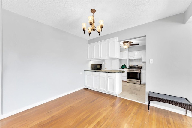 9205 Potter Rd Unit 1C, Des Plaines, IL 60016 - kitchen featuring stainless steel gas range, black microwave, a chandelier, white cabinetry, and light wood finished floors