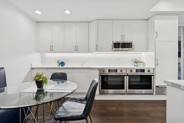 680 N Lake Shore Dr Unit 321, Chicago, IL 60611 - kitchen with stainless steel microwave, dark wood-type flooring, recessed lighting, light countertops, and white cabinets