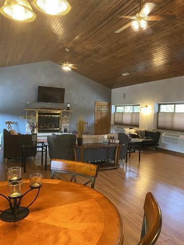 5918 Park Ridge Rd, Loves Park, IL 61111 - dining space featuring a ceiling fan, wooden ceiling, lofted ceiling, a fireplace, and wood finished floors